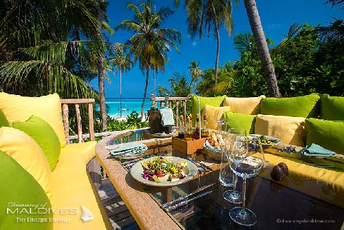 Gili Lankanfushi Maldives - The 360 Table surrounded by lounge benches and huge colourful pillows